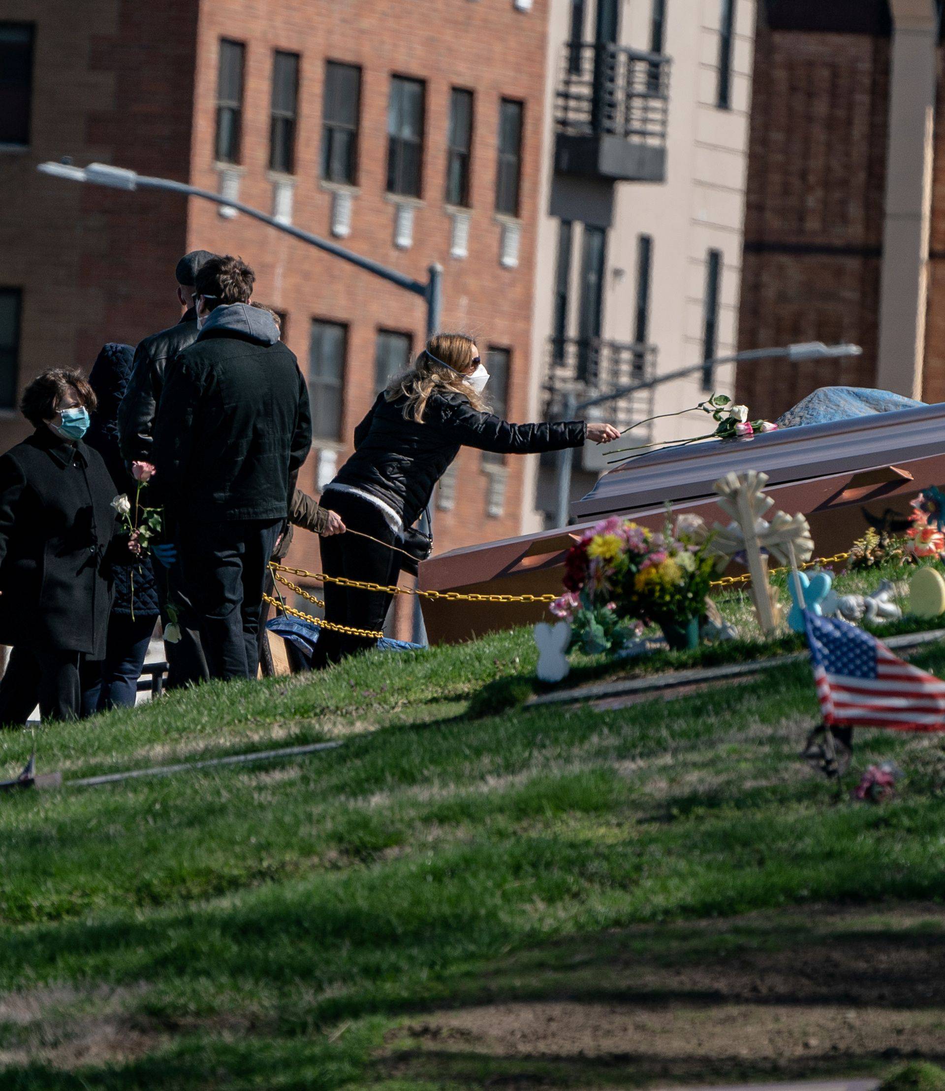 Mourners attend a funeral at The Green-Wood Cemetery during the outbreak of the coronavirus disease (COVID-19) in the Brooklyn borough of New York City