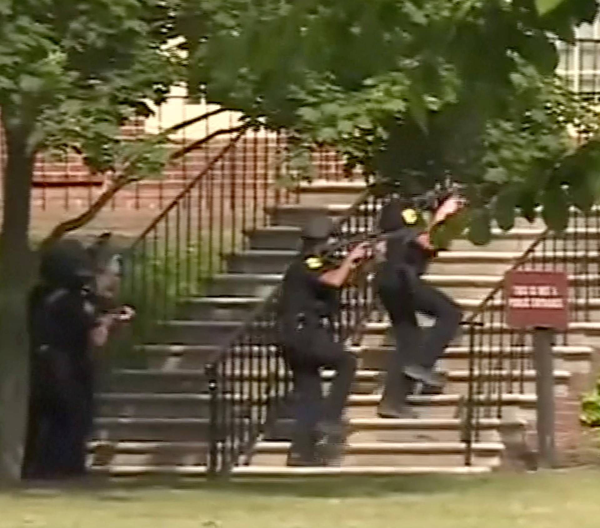 Police enter a building in this still image taken from video following a shooting incident at the municipal center in Virginia Beach