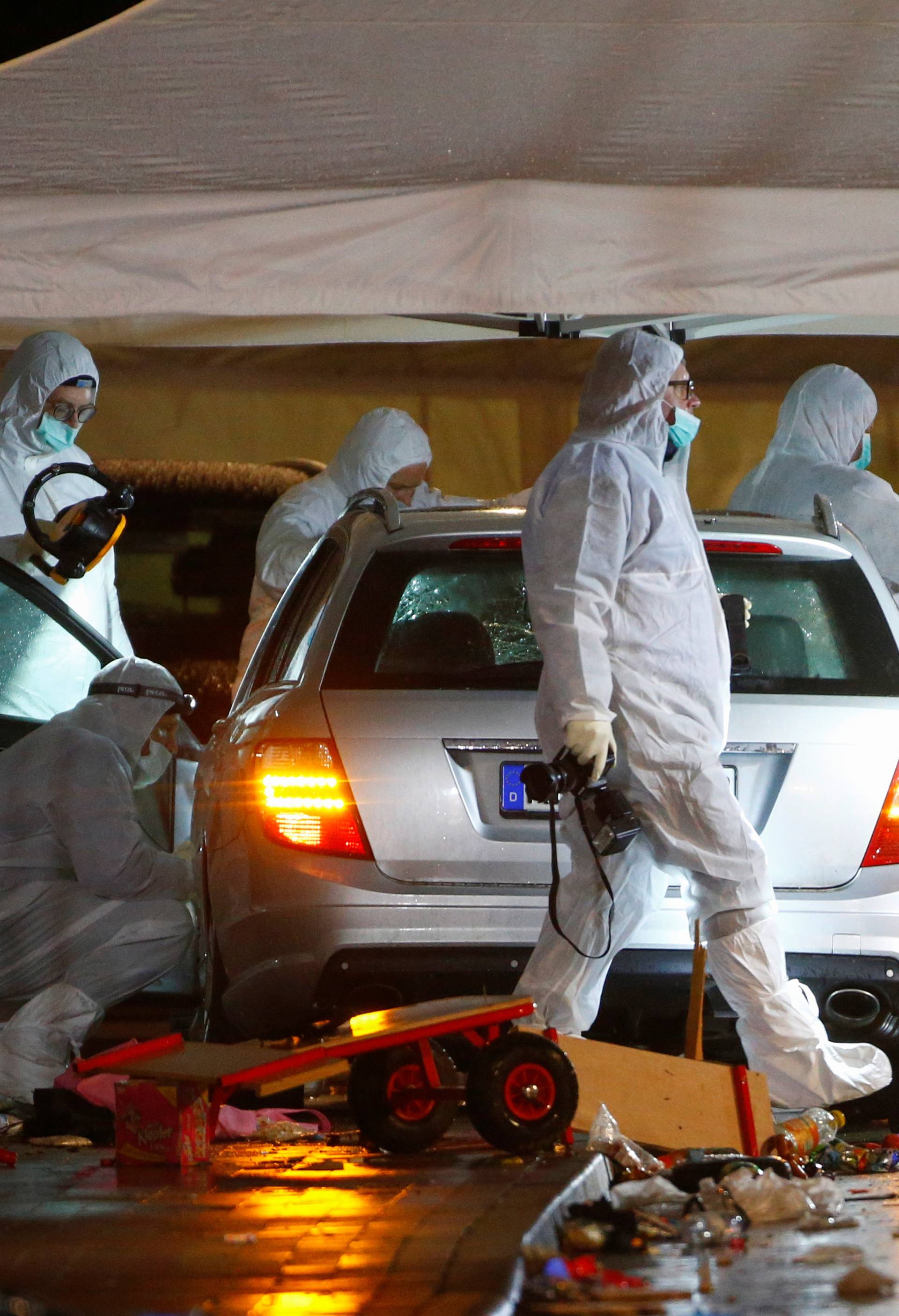 Police forensic officers work at the scene after a car ploughed into a carnival parade injuring several people in Volkmarsen