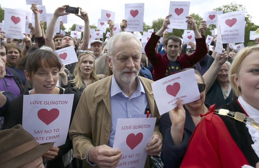 Britain's opposition Labour Party leader Jeremy Corbyn poses with supporters after speaking at an anti-racism rally in London