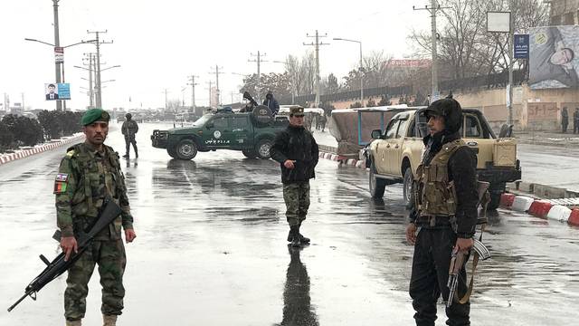 Afghan security forces stand near the Marshal Fahim military academy after a series of explosions in Kabul