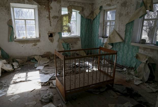 Ð baby cot is seen in a house in the abandoned village of Zalesye near the Chernobyl nuclear power plant