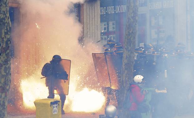 French riot police officers (CRS) face protestors during clashes during a demonstration against the French labour law proposal in Paris