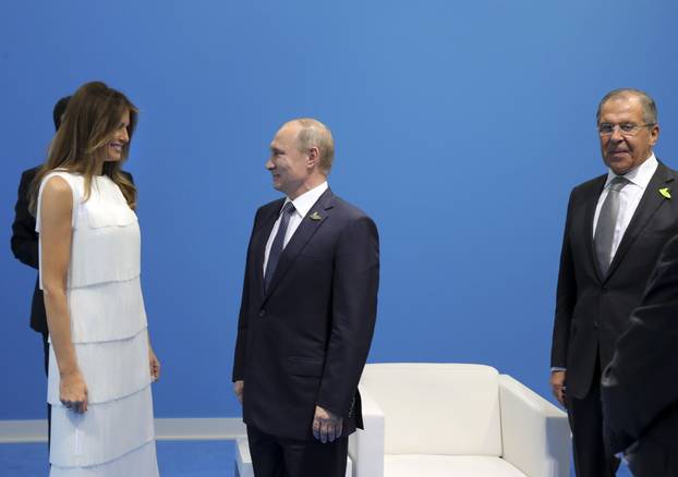 Russian President Vladimir Putin, Foreign Minister Sergei Lavrov and U.S. First Lady Melania Trump attend a meeting on the sidelines of the G20 summit in Hamburg