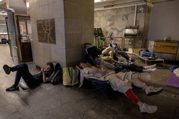 People take shelter in a metro station during Russian drone and missile strikes in Kyiv