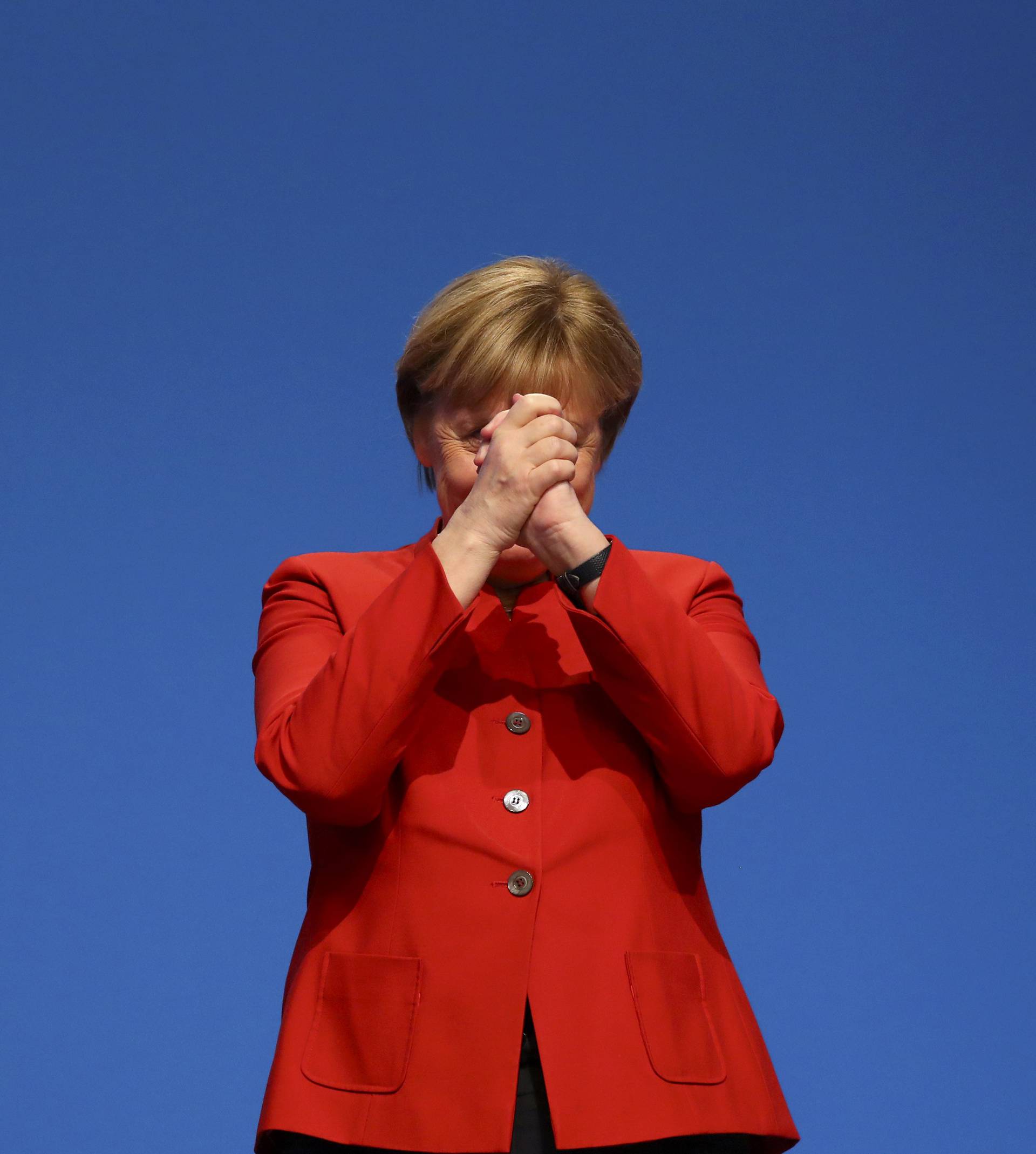 German Chancellor and leader of the conservative CDU Merkel reacts after her speech at the CDU party convention in Essen