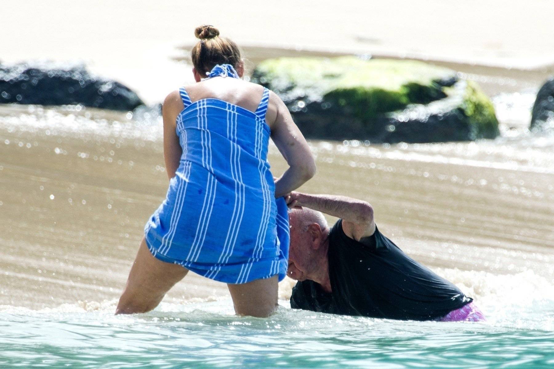 *EXCLUSIVE* Jerry Hall catches her husband Rupert Murdoch as he stumbles on the beach