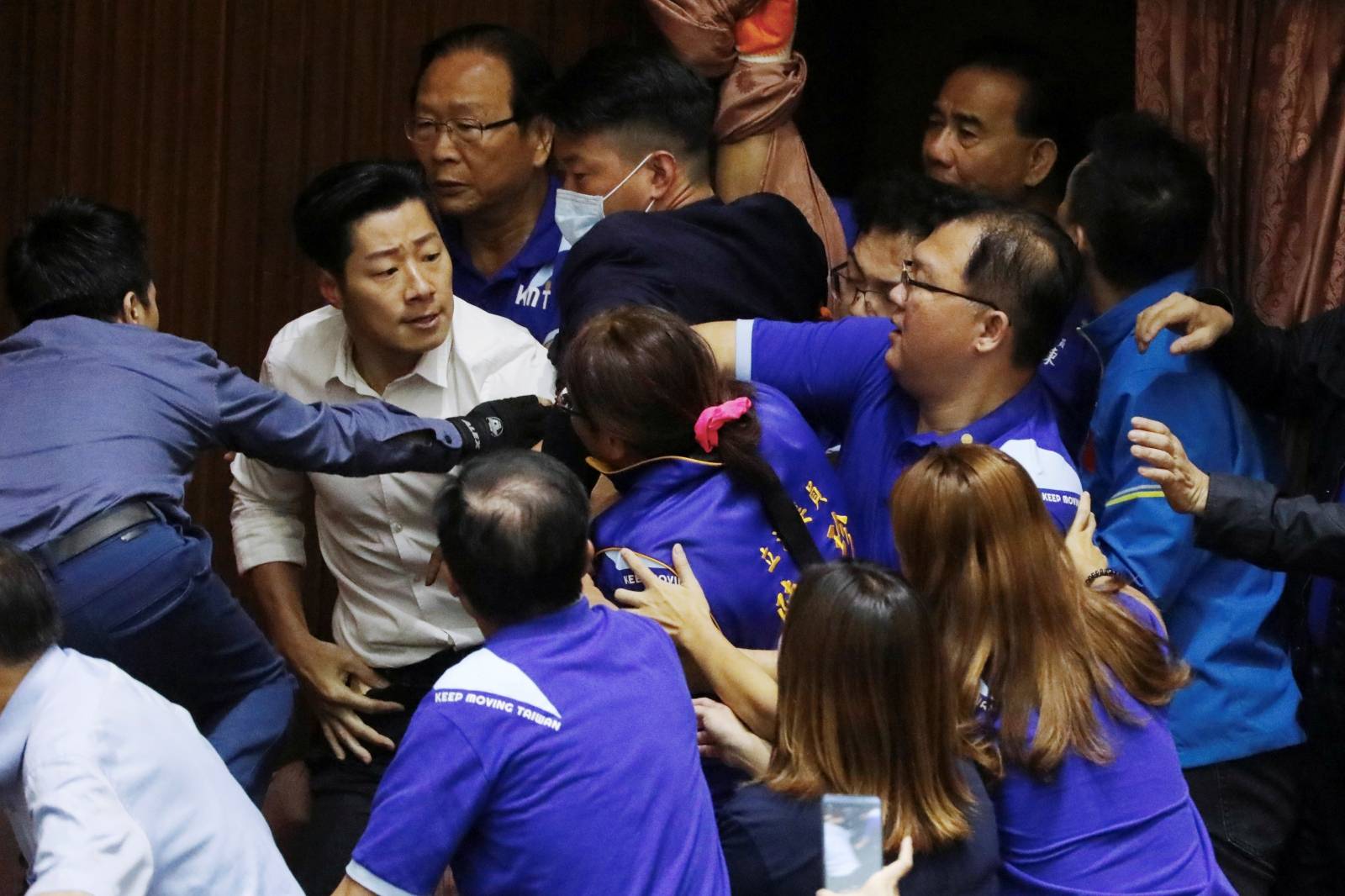 Lawmakers from Taiwan's ruling Democratic Progressive Party (DPP) scuffle with lawmakers from the main opposition Kuomintang (KMT) party, who have been occupying the Legislature Yuan, in Taipei