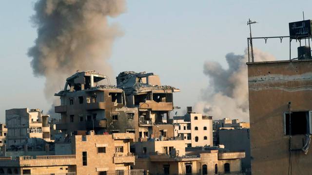 Smoke billows at different positions of the Islamic State militants at the stadium after an air strike by coalition forces, at the frontline in Raqqa