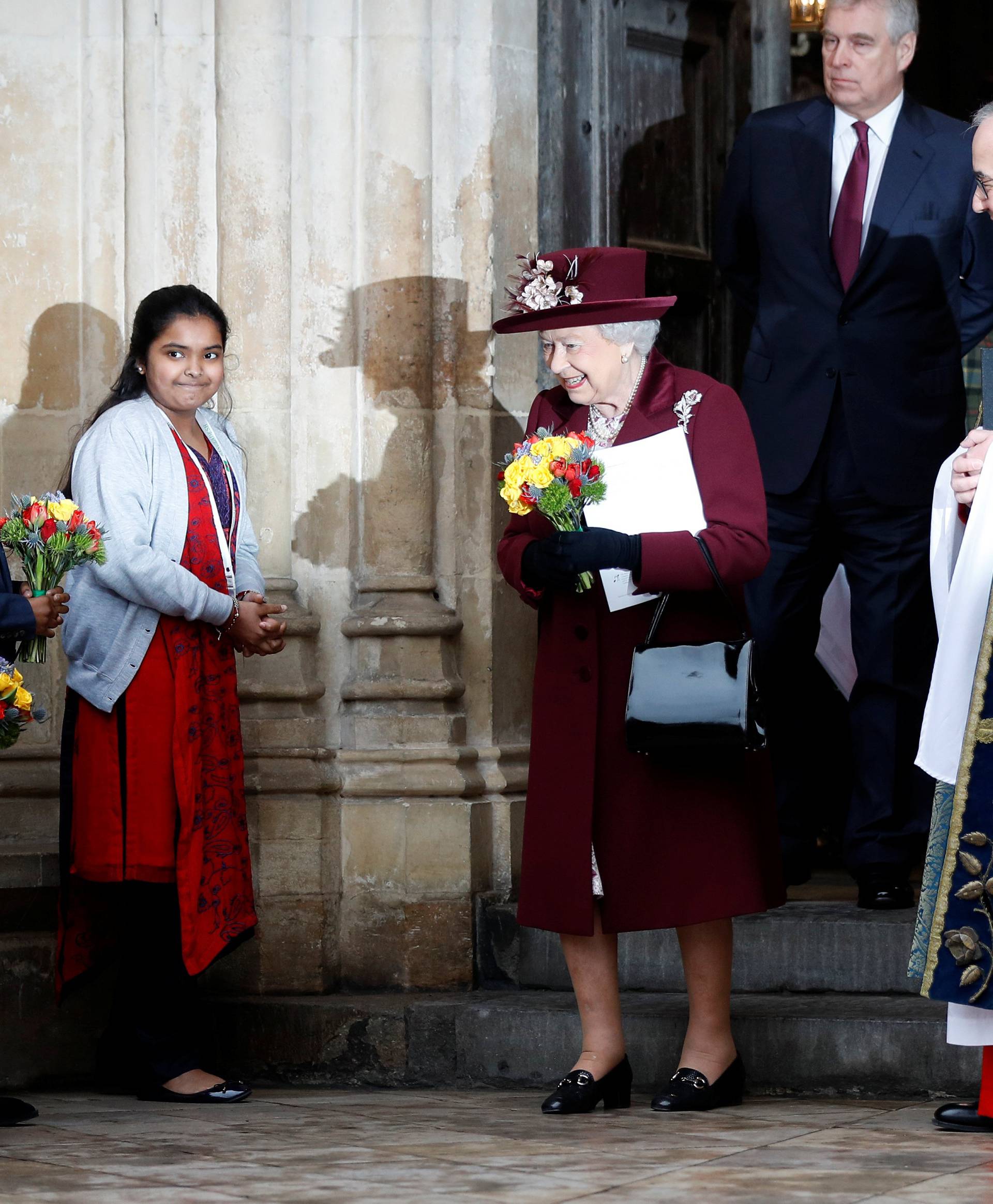 Britain's Queen Elizabeth smiles after receiving a bouquet of flowers after attending the Commonwealth Service at Westminster Abbey in London