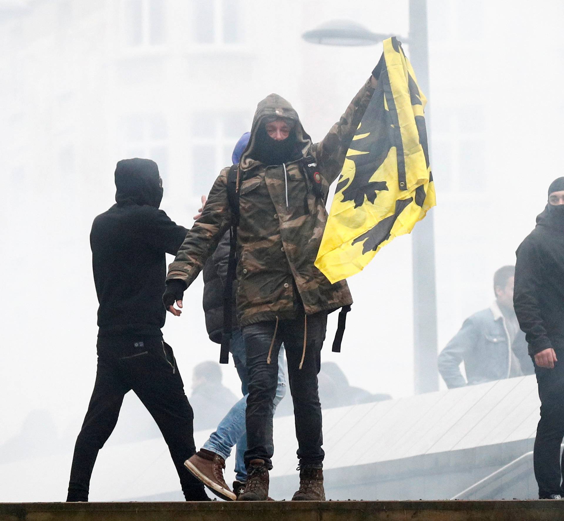 Flemish nationalist holds a Flemish flag as he attends a protest against Marrakesh Migration Pact in Brussels