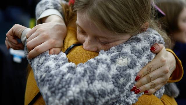 Valeriia, who was taken to Russia, embraces her mother Anastasiia after returning via the Ukraine-Belarus border, in Kyiv