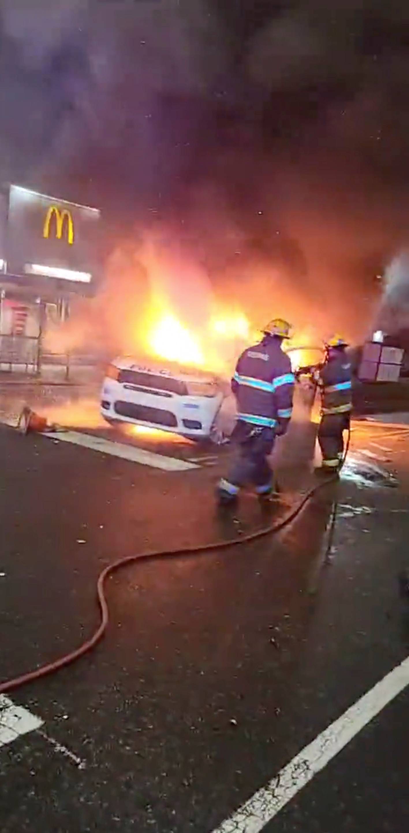 Police vehicle burns during protests after police shooting death of Wallace Jr. in Philadelphia, Pennsylvania