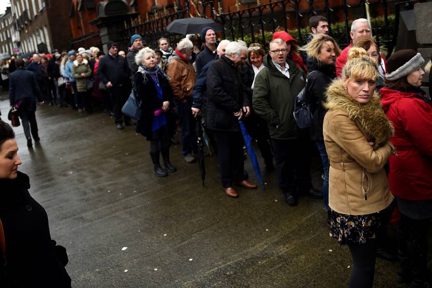 Members of the public queue to see Cranberries singer Dolores O'Riordan's coffin as it is carried into St. Joseph's Church for a public reposal in Limerick