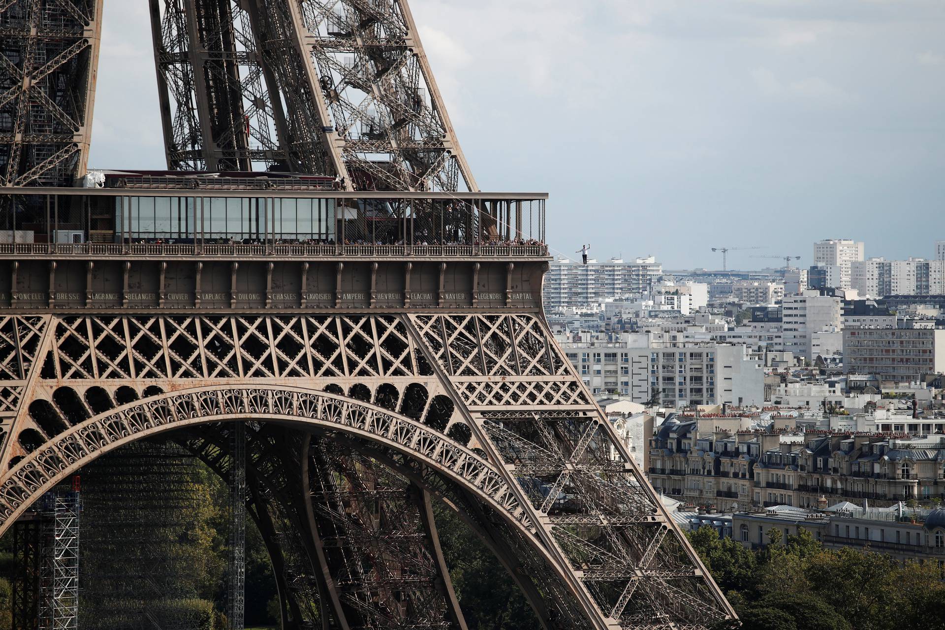 French acrobat Nathan Paulin walks on a slackline between the Eiffel Tower and the Theatre National de Chaillot as part of events around France for National Heritage Day