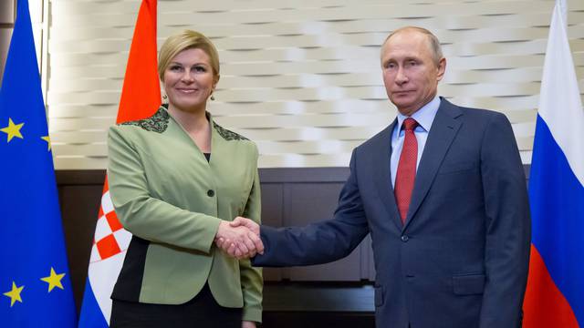 Putin shakes hands with Croatian President Kolinda Grabar-Kitarovic during their meeting in Sochi