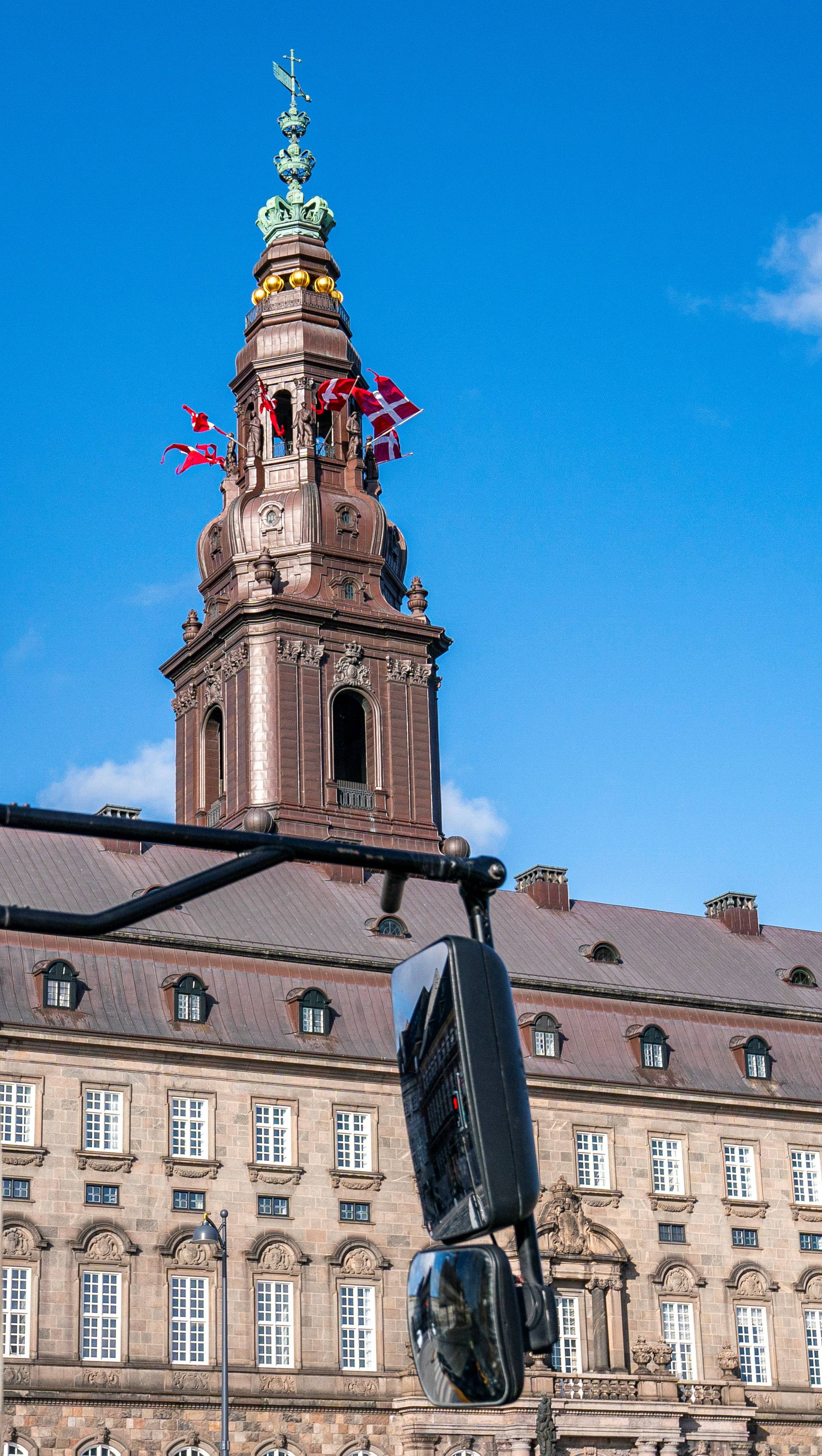 Flags flutter on the Christiansborg Palace People on the birthday of Danish Queen Margrethe, as the spread of the coronavirus disease (COVID-19) continues, in Copenhagen