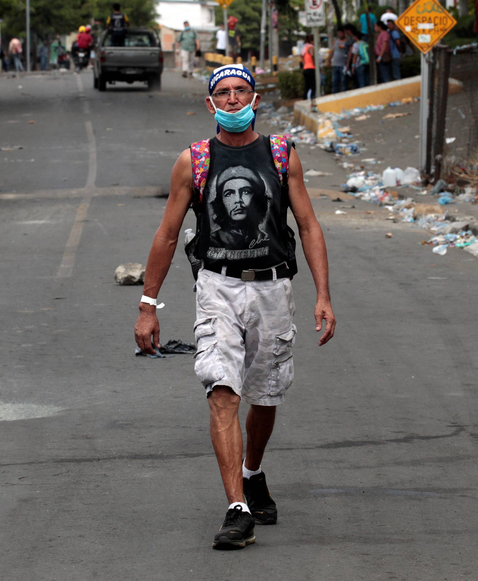 A demonstrator walks outside a university during a protest in Managua