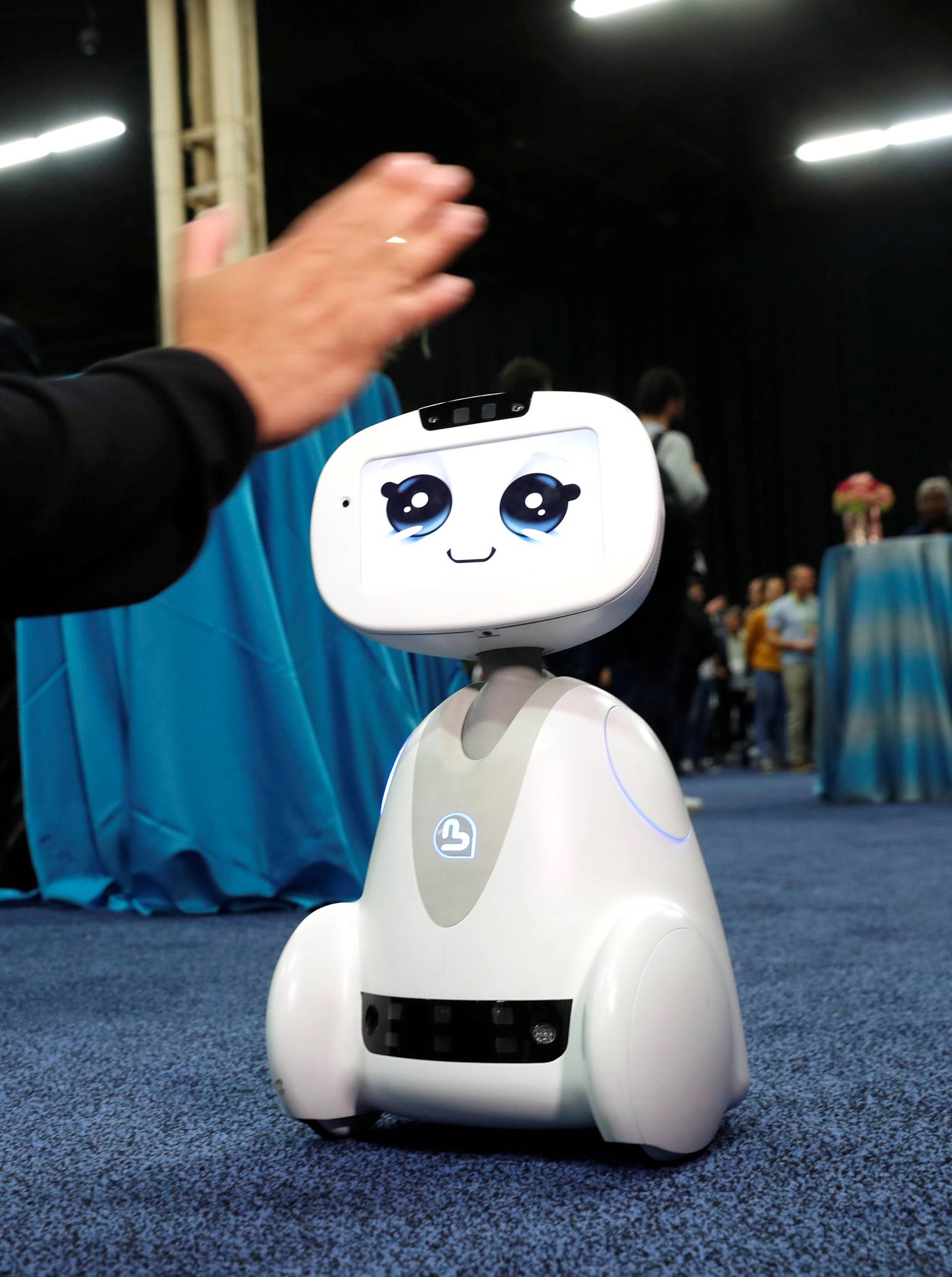 Buddy, an entertainment and assistant robot by Blue Frog Robotics, interacts with a attendee during CES Unveiled at the 2018 CES in Las Vegas