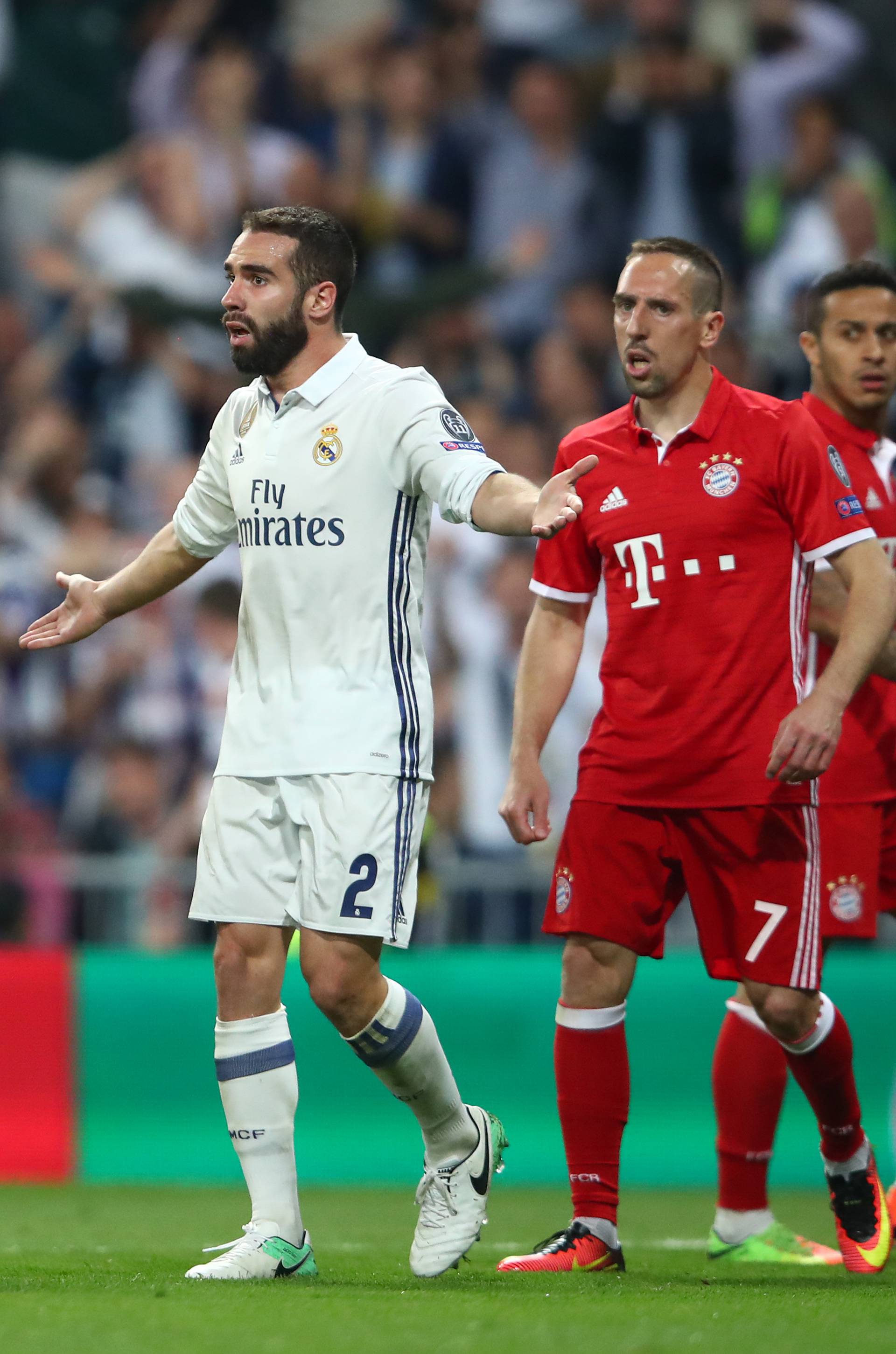 Referee Viktor Kassai awards a penalty to Bayern Munich as Bayern Munich's Arturo Vidal and Real Madrid's Daniel Carvajal react