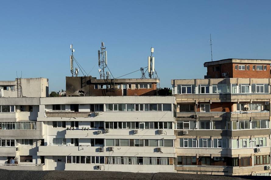 Firefighters and law enforcement work on the site of an explosion at a residential block of flats following a drone hit close to the border with Ukraine