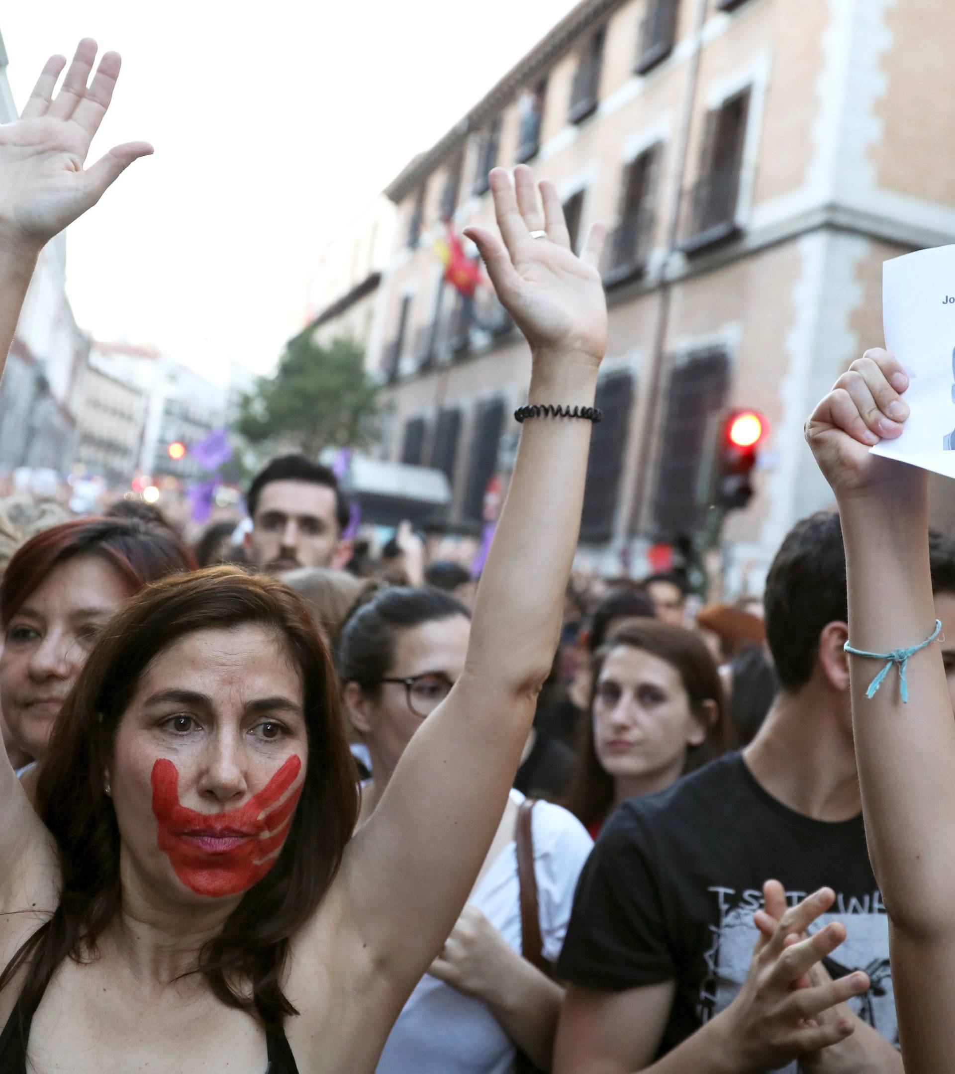 A woman raises her arms during a protest outside Ministry of Justice in Madrid