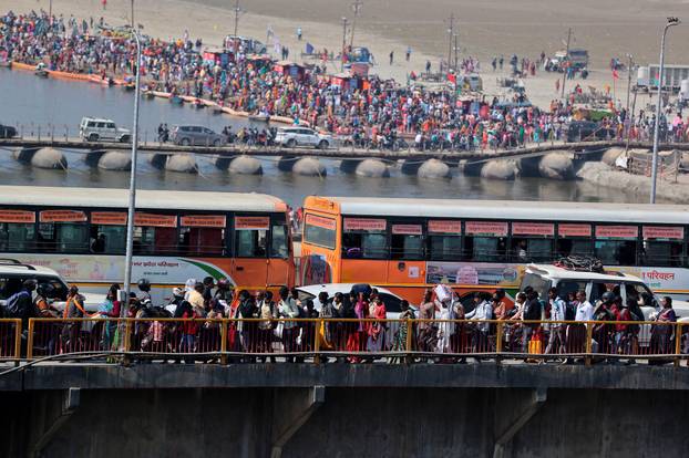 Hindu devotees move through a crowded bridge near Sangam during the "Maha Kumbh Mela" in Prayagraj