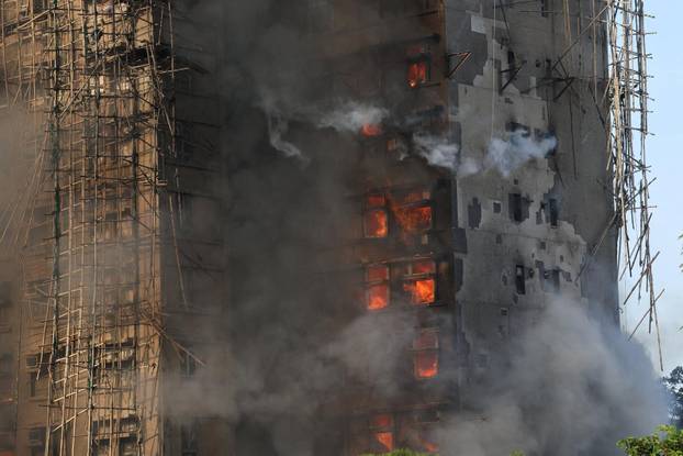 Flames engulf bamboo scaffolding across multiple buildings at Wang Fuk Court housing estate, in Tai Po