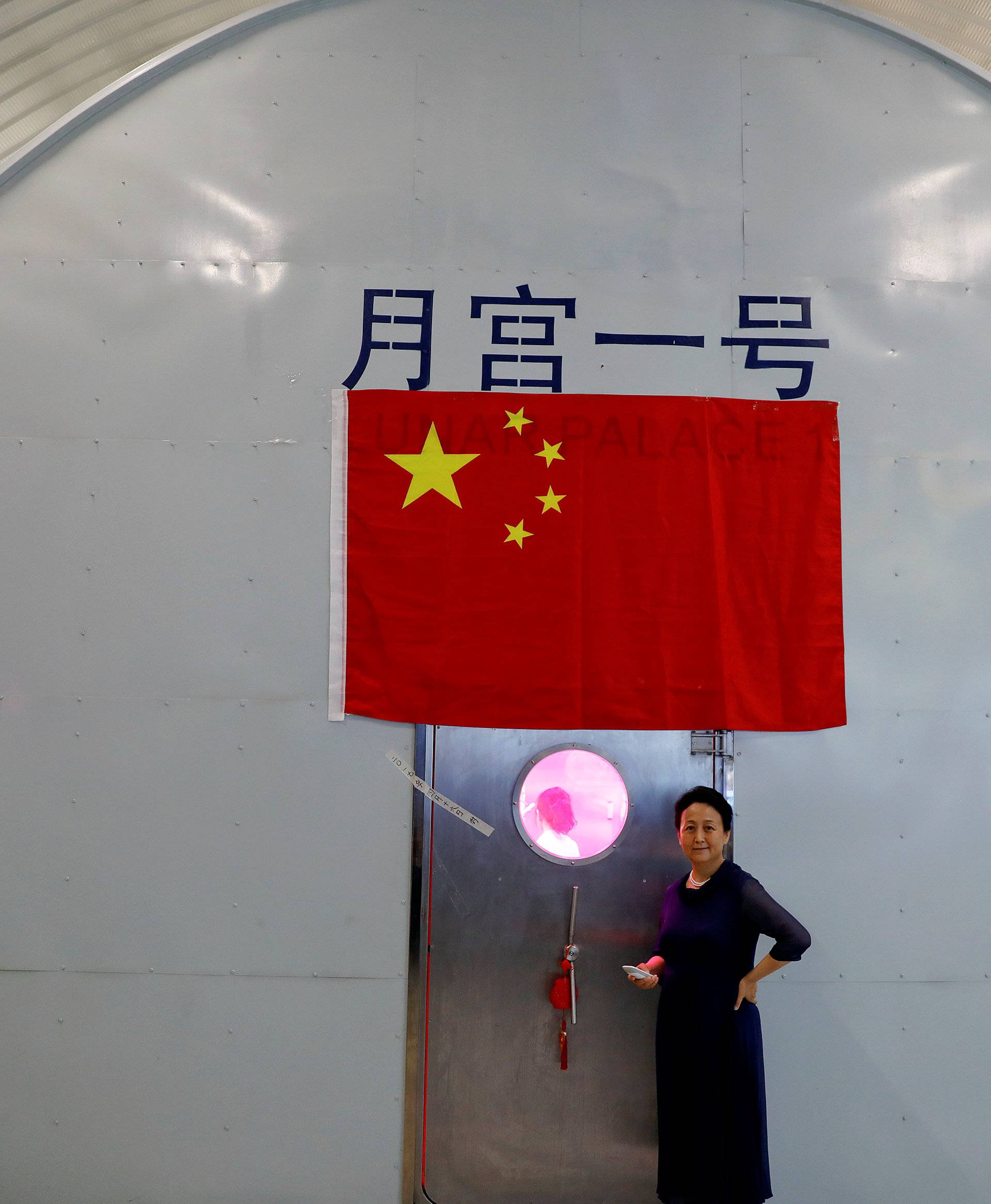 Liu Hong, chief designer of the Lunar Palace 365 Project stands outside a simulated space cabin in which volunteers temporarily live as a part of the project at Beihang University in Beijing