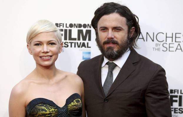 Actors Michelle Williams and Casey Affleck pose for photographers at a Gala screening of their film "Manchester by the Sea" at the 60th BFI London Film Festival in London