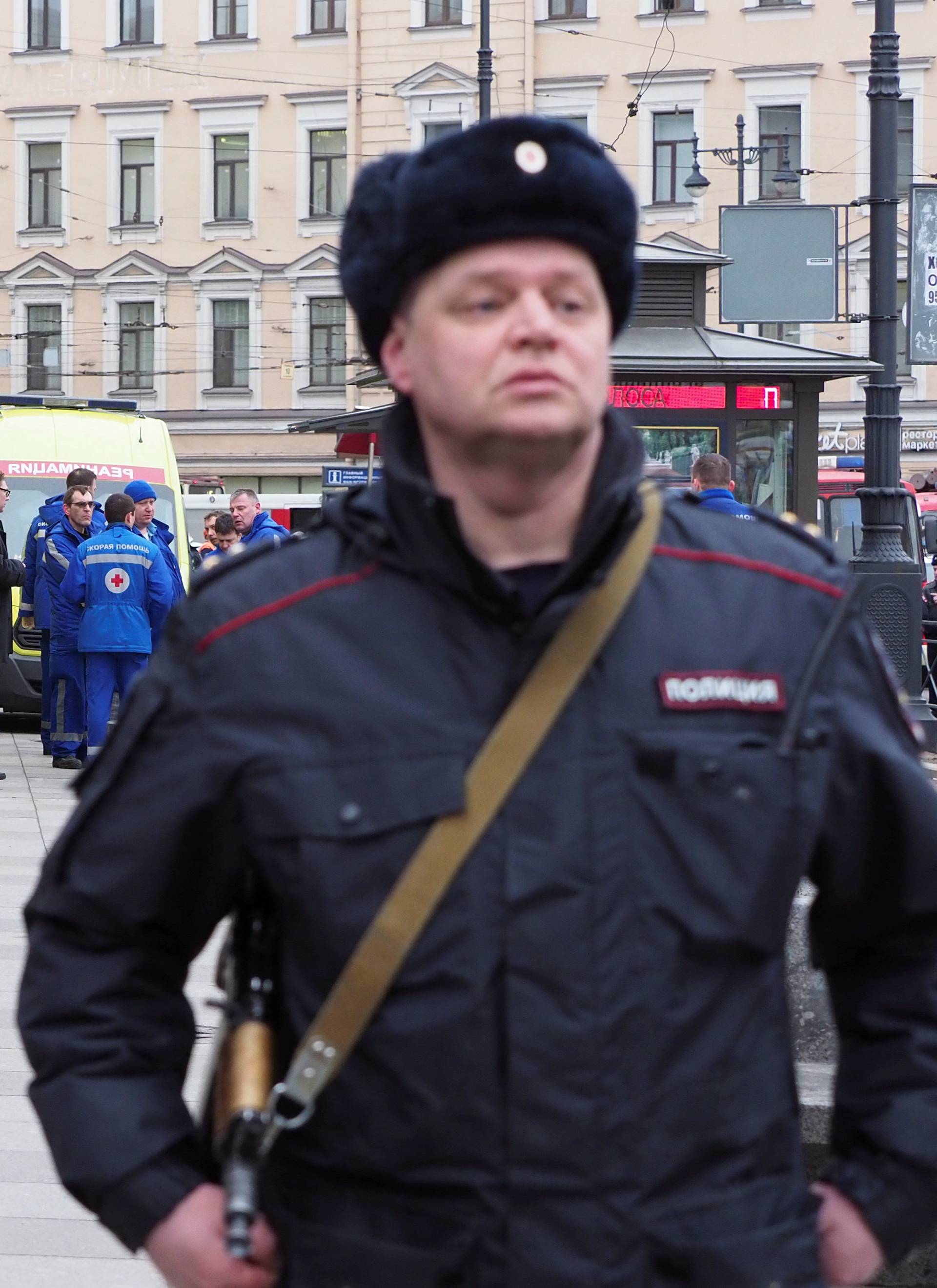 Police officers and members of Emergency services are seen outside Tekhnologicheskiy Institut metro station in St. Petersburg