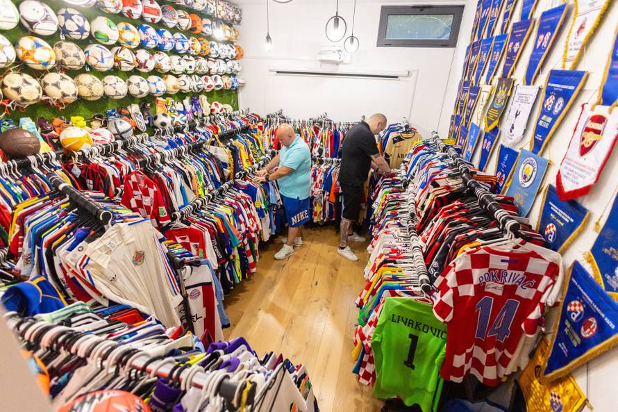 Davor Tislar and Marko Senicnjak search for football jerseys among their collection of jerseys and other memorabilia, in Zagreb