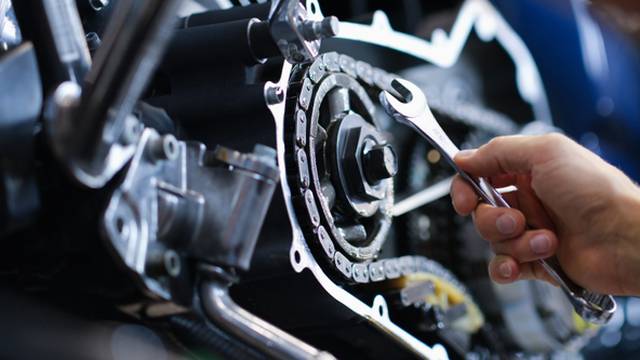 Master,Repairman,Repairing,Motorcycle,With,Wrench,Closeup