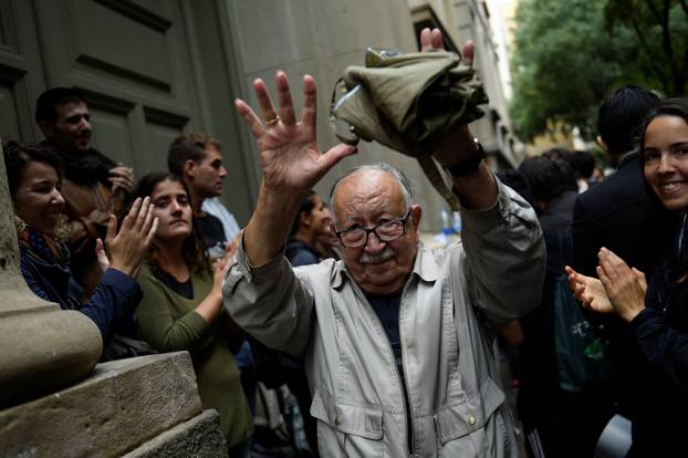 A man reacts as he leaves a polling station after casting his vote for the banned separatist referendum in Barcelona