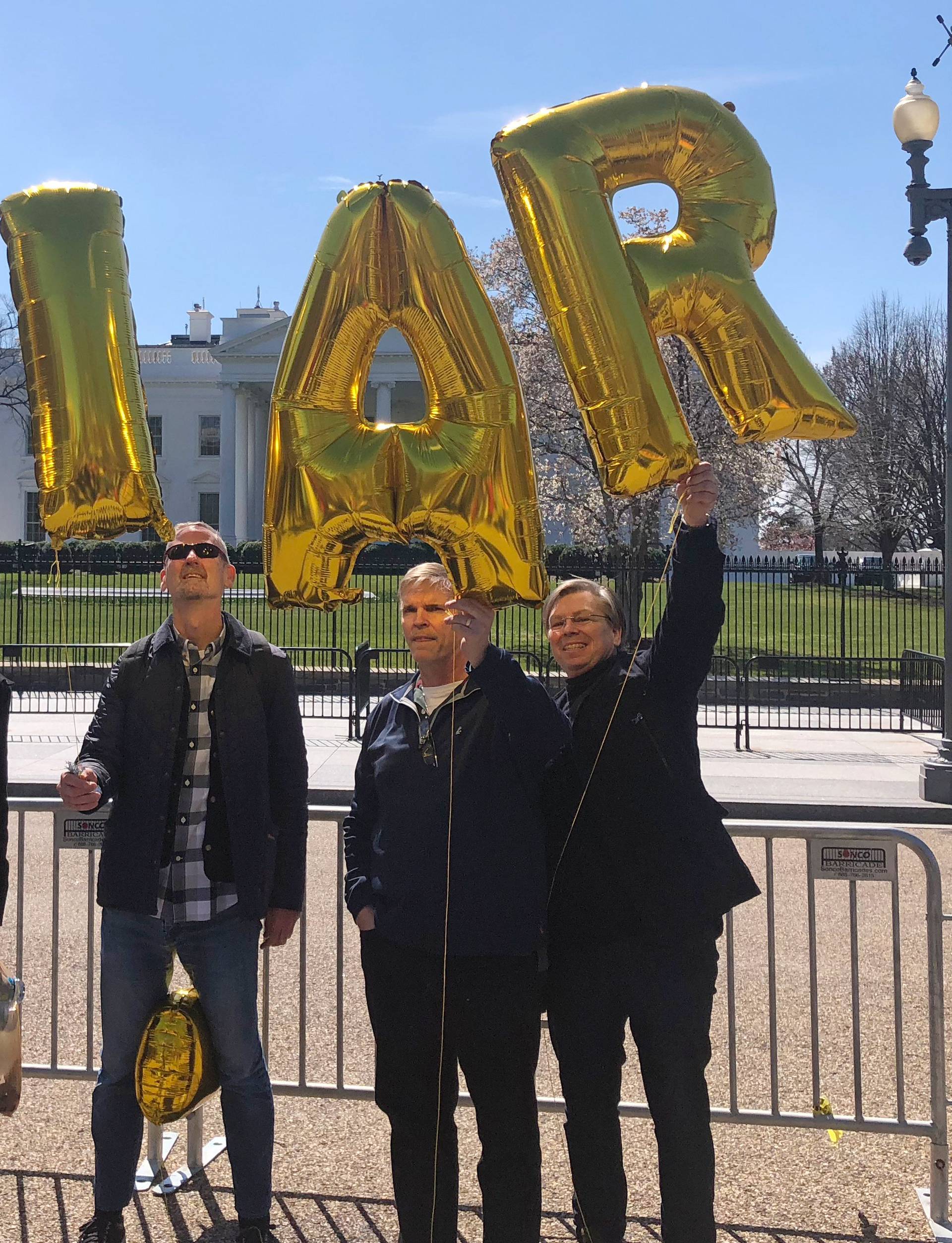 Andy Pollock of Boston; Alan Gambrell of Washington; Jeffrey Schmalz of Dartmouth, Massachusetts and Jamie OâDay of Washington hold balloons that spell out âLIARâ in front of the White House in Washington