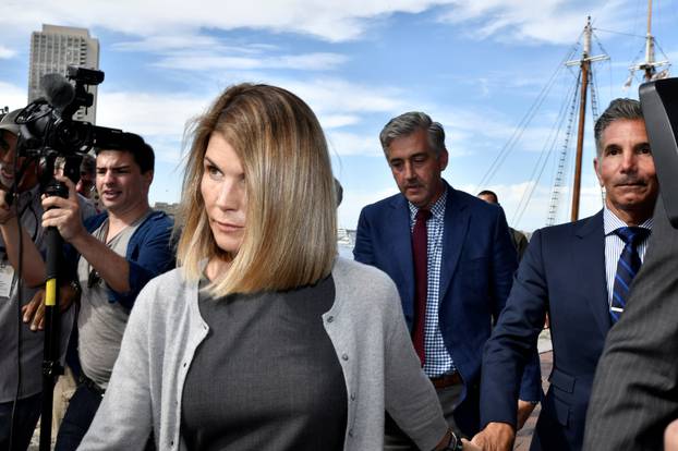 FILE PHOTO: Actress Lori Loughlin, and her husband, fashion designer Mossimo Giannulli leave the federal courthouse after a hearing on charges in a nationwide college admissions cheating scheme in Boston