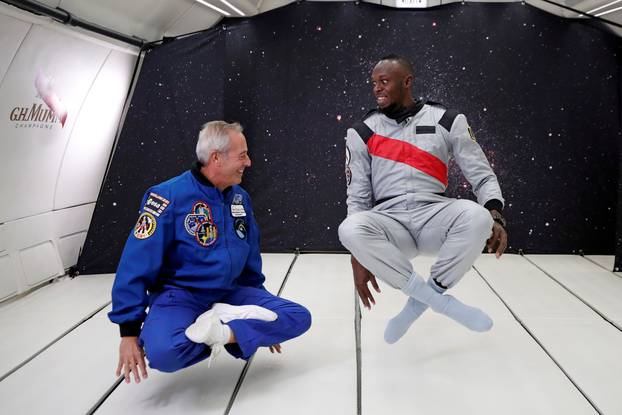 Retired sprinter Usain Bolt and French astronaut Jean-Francois Clervoy enjoy zero gravity conditions during a flight in a specially modified plane above Reims