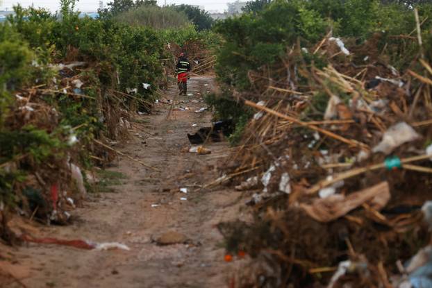 Members of the military search for bodies of people missing after heavy rains, in Quart de Poblet