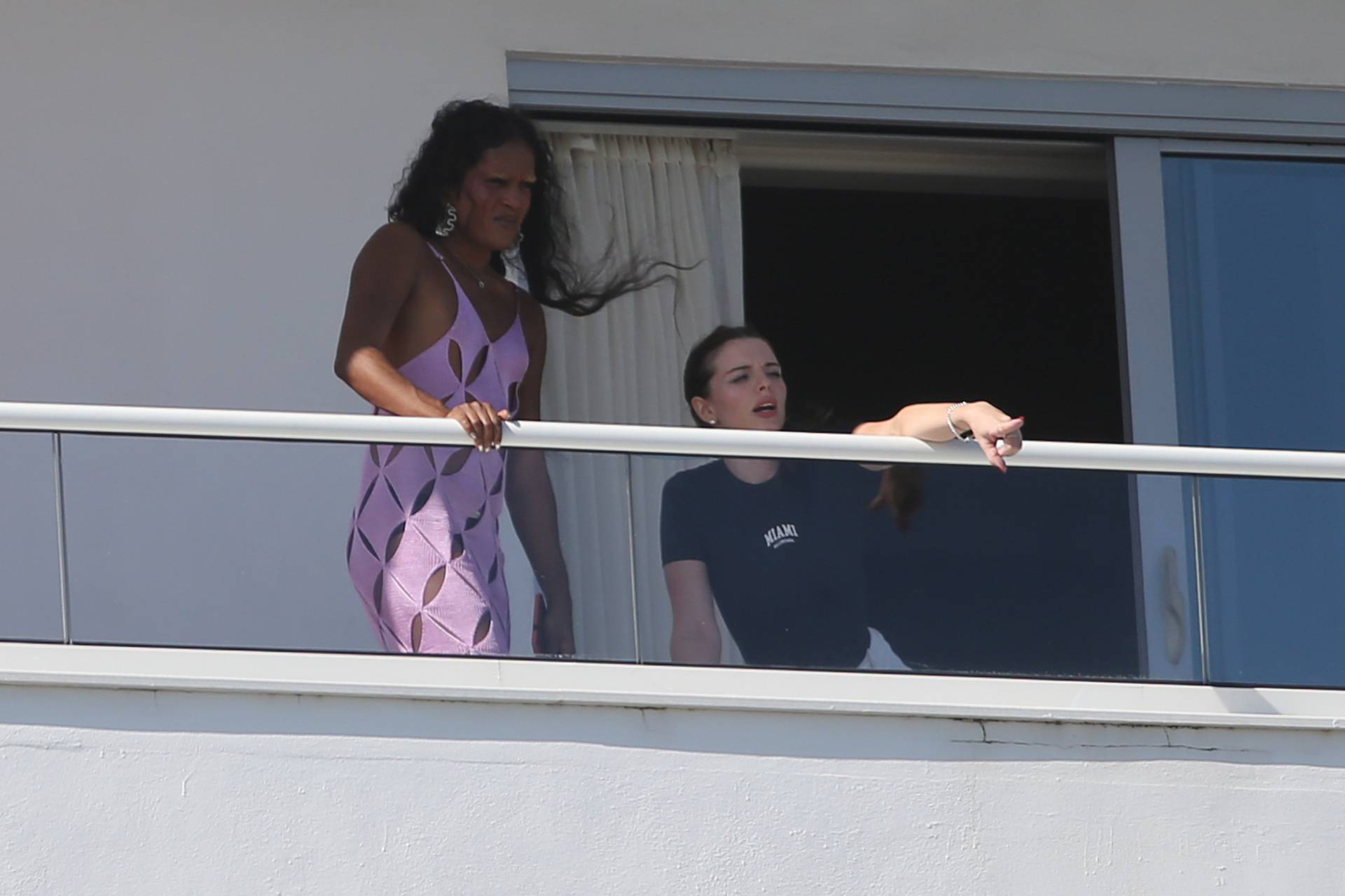 Actress Julia Fox is seen with a pal on Kanye West's hotel balcony, the day after enjoying a romantic dinner date with the rapper.