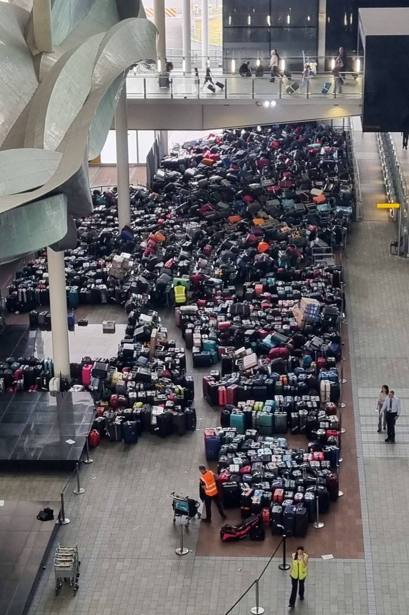 Hundreds Of Suitcases Continue To Mount Up At Heathrow Terminal 2 This Morning