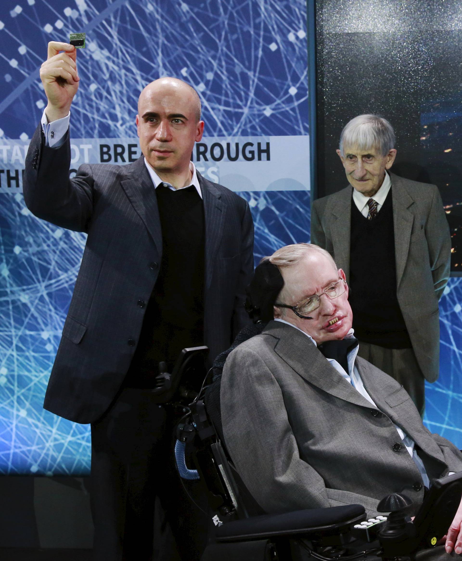 Physicist Stephen Hawking sits in front of  investor Yuri Milner (L), physicist Freeman Dyson (C), and physicist Avi Loeb on stage during an announcement of the Breakthrough Starshot initiative in New York