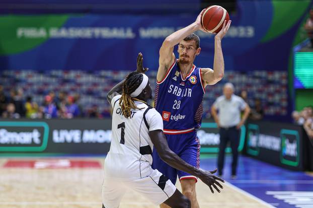 MANILA, PHILIPPINES - AUGUST 30: Borisa Simanic 28 of Serbia drives the ball against Nuni Omot 1 of South Sudan during t