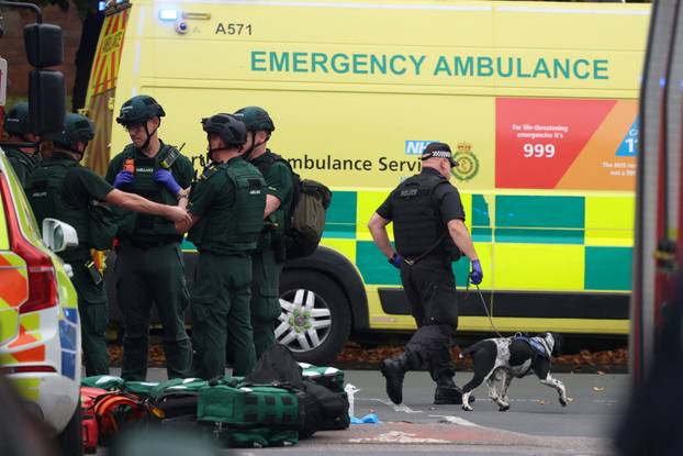 Police officers work at the scene following an incident outside a synagogue, in Manchester