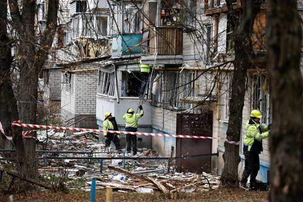 Emergency responders work at the site of a Russian drone strike on an apartment building, in Kyiv