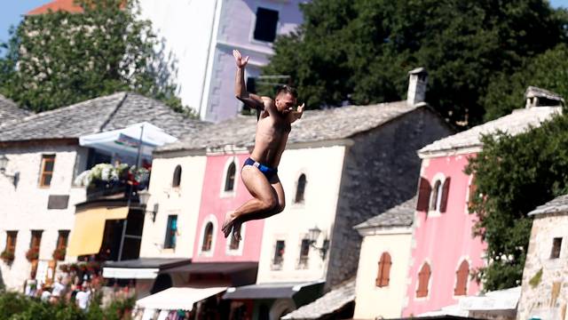 A man jumps from the Old Bridge during 450th traditional diving competition in Mostar