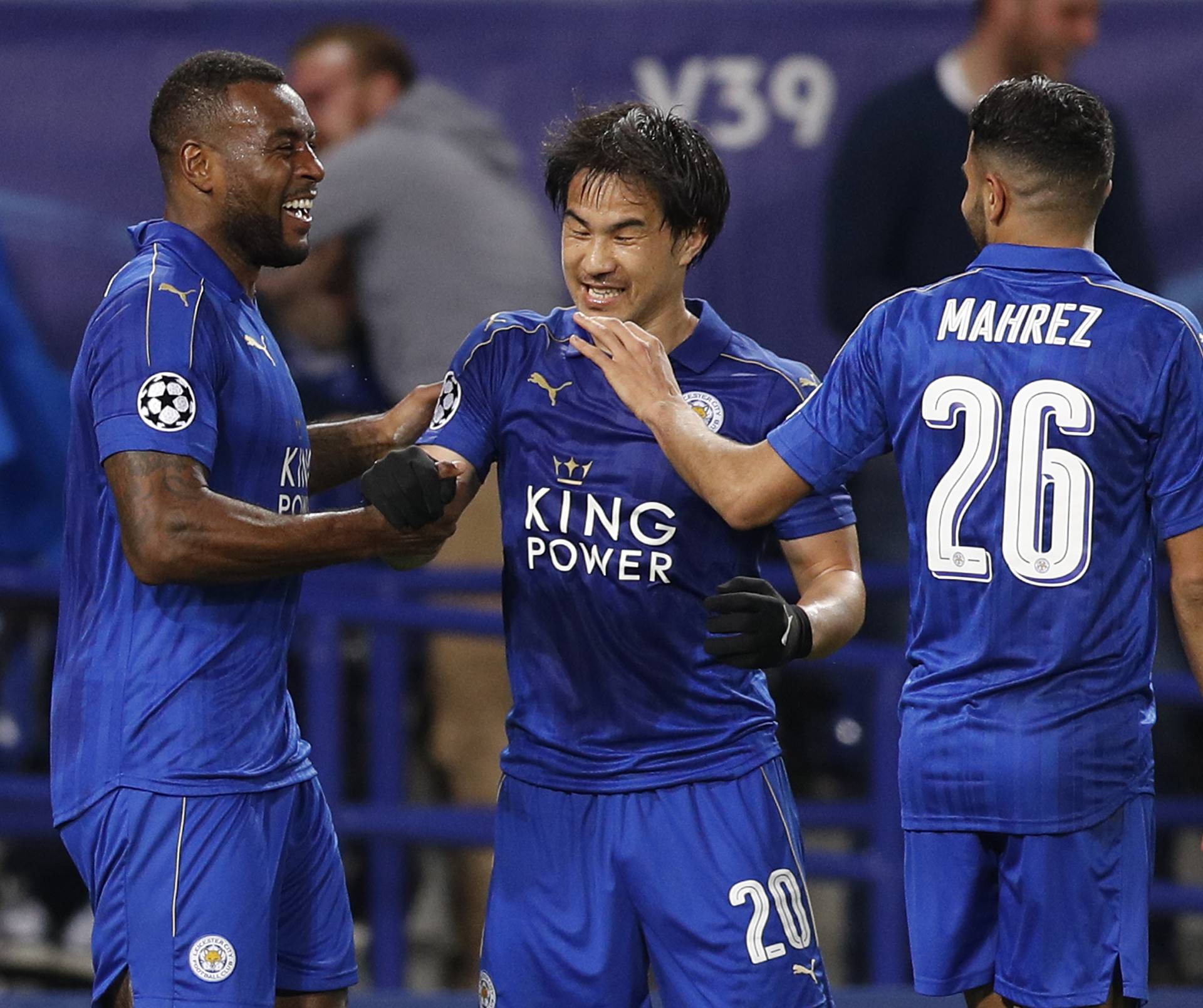 Leicester City's Wes Morgan celebrates with Shinji Okazaki and Riyad Mahrez after scoring their first goal