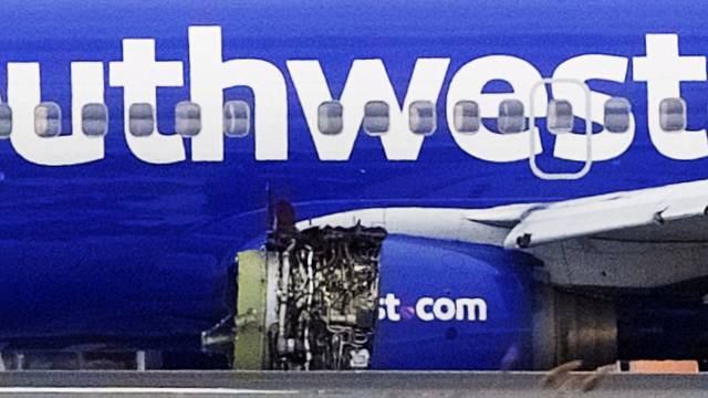 Emergency personnel monitor the damaged engine of Southwest Airlines Flight 1380, which diverted to the Philadelphia International Airport this morning, in Philadelphia, Pennsylvania