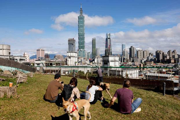 People gather to watch climber Alex Honnold free soloing Taipei 101 Skyscraper in Taipei