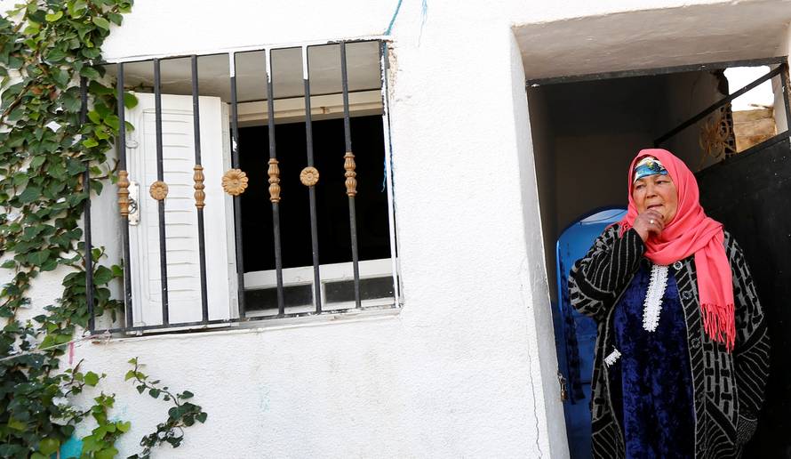 Nour, mother of suspect Anis Amri who is sought in relation with the truck attack on a Christmas market in Berlin, reacts near their home in Oueslatia, Tunisia