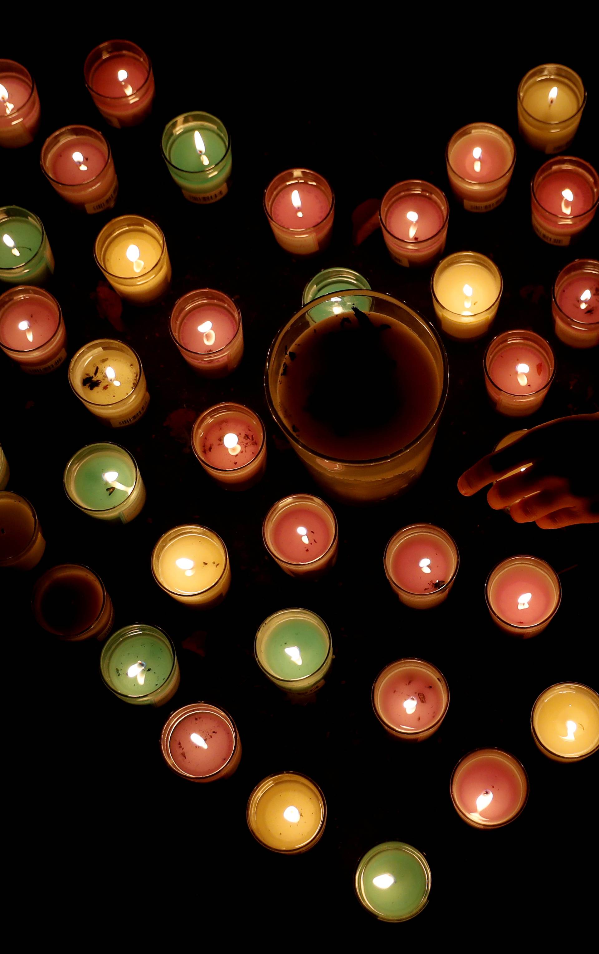 Candles arranged in a heart shape burn at a memorial site for victims of the mosque shootings at the Botanic Gardens in Christchurch